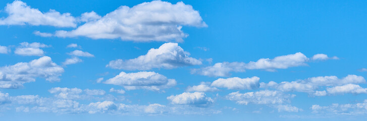 large white clouds on a clear blue sky background