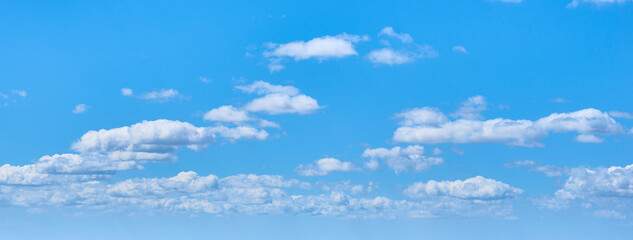 White clouds on a clear blue sky background