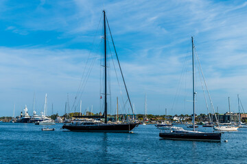 A view past boats moored in the harbor at Newport, USA in the fall