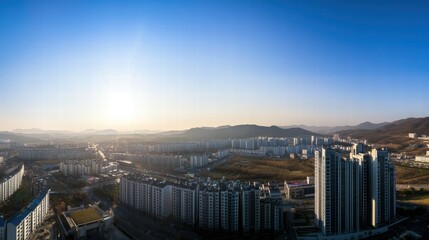 Sunrise Cityscape: A panoramic view captures the sprawling urban landscape as the sun rises over the city, casting a warm glow over towering buildings.