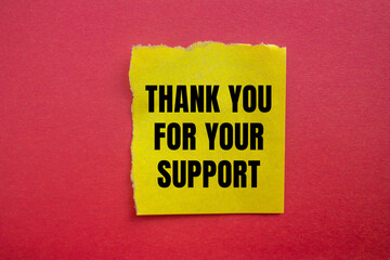 Thank you for your support message written on ripped torn yellow paper piece with red background. Conceptual thank you for your support symbol. Copy space.