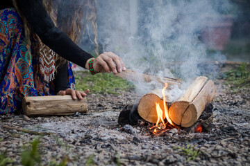 Sao Paulo, SP, Brazil - November 17 2024: Close-up of female hands lighting a fire details.
