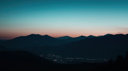 Serene Sunset over Mountain Range and City Lights