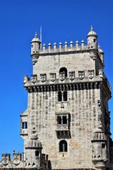 Fototapeta premium Belem Tower in Lisbon, Portugal, built of limestone, with Gothic architectural decorations. Light blue sky in the background
