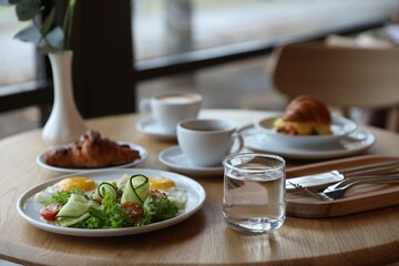 Delicious breakfast served on wooden table in cafe
