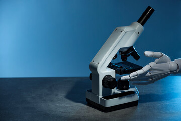 Artificial intelligence. Robot hand working with microscope at grey table against blue background, space for text