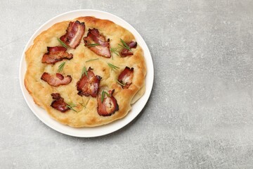 Delicious focaccia bread with bacon and parsley on light grey table, top view. Space for text