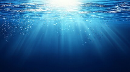 Underwater scene with sun rays, bubbles, and deep blue water.