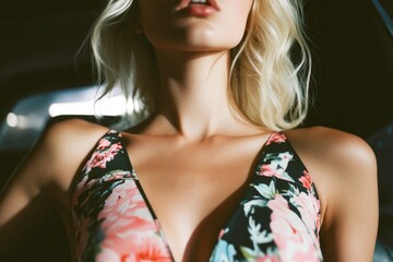 A woman posing in a colorful floral dress