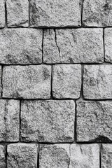 Fototapeta premium A close-up shot of a worn-out brick wall in monochrome