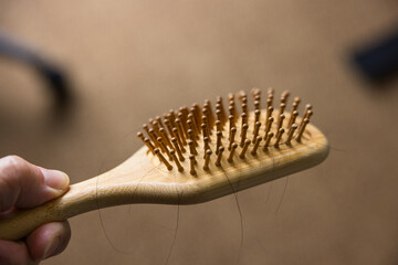 Wooden comb with hair loss