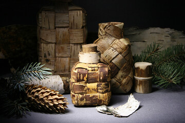 Birch bark products. Still life with souvenir wicker bottles. Handmade bottles.