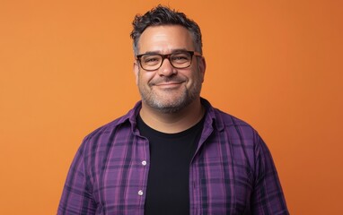 Fototapeta premium An overweight man in a purple plaid shirt and a black T-shirt, with short dark hair and a light beard, glasses on