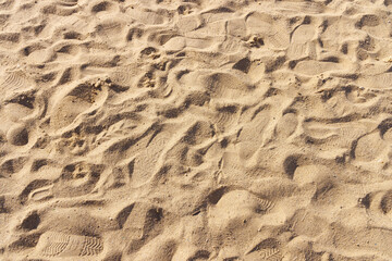 Footprints on the surface of dry sand. View from above.