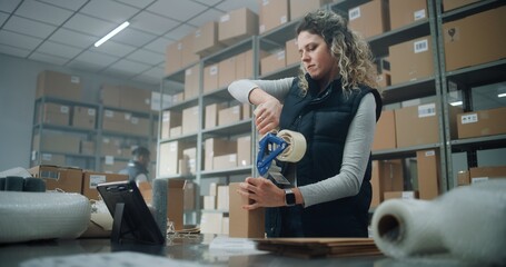 Female Warehouse Clerk, Postal Worker Packs Cardboard Box with Online Order, Prepares Parcel for Shipping to Customer, Uses Tablet Computer. Sorting Center of E-Commerce Store, Delivery Service.