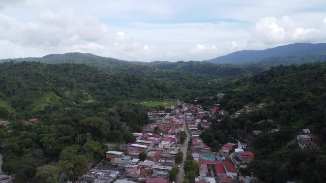 Aerial view of Chuspa, Venezuela &ndash; Coastal fishing village surrounded by lush green mountains and tropical forest, beach shoreline and calm sea, beautiful natural landscape