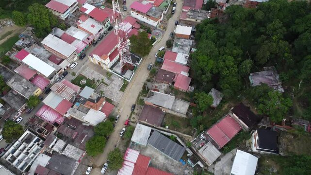 Aerial view of Chuspa, Venezuela &ndash; Coastal fishing village surrounded by lush green mountains and tropical forest, beach shoreline and calm sea, beautiful natural landscape