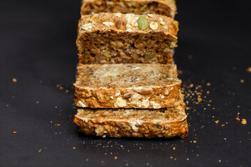 Freshly sliced whole grain bread on a dark background
