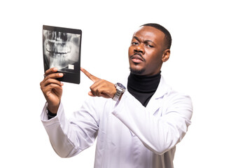 Confident dentist holding and examining an x-ray with a serious expression in a studio setting, highlighting dental care and medical professionalism
