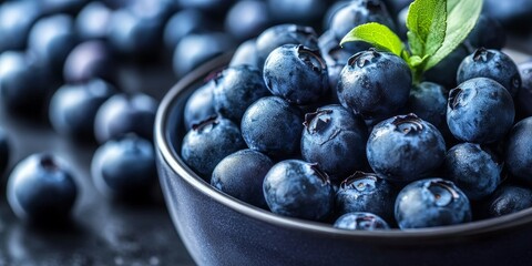Organic superfood blueberries are rich in antioxidants, making them an ideal choice for healthy eating and nutrition. This bowl of blueberries showcases the benefits of this superfood.