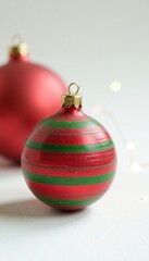 Red and green striped wooden ball on white background, ornaments, decoration