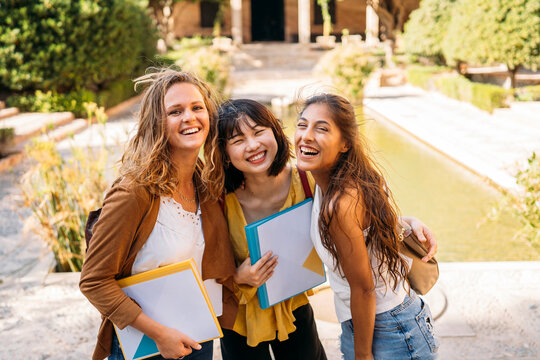 University exchange students laughing together on campus