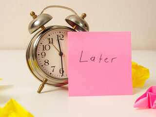 Clock with sticker “Then later”: a symbol of procrastination, a reminder that sometimes you...