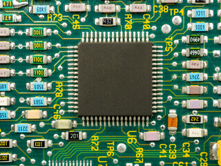 Close-up of microcircuits and components: chips, diodes and capacitors on a printed circuit board,...