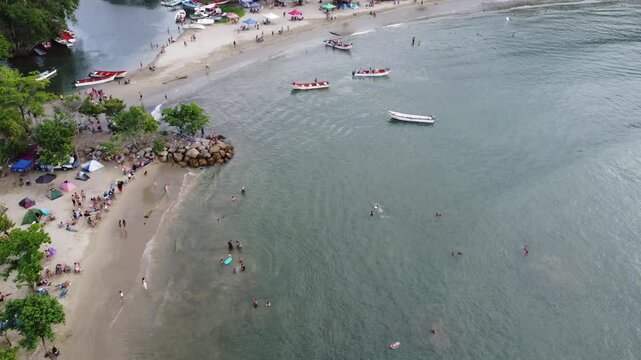Aerial view of Chuspa, Venezuela &ndash; Coastal fishing village surrounded by lush green mountains and tropical forest, beach shoreline and calm sea, beautiful natural landscape