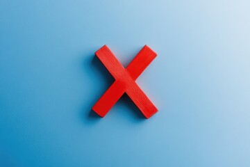 Obraz premium A simple red X mark against a bright blue background