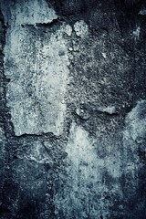 Obraz premium A black and white photograph of an old brick wall with cracks and texture