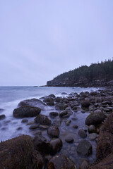 This beautiful section of rocky, boulder strewn coastline is located in Acadia National Park. This picture was taken at twilight on an overcast day, the light is muted.