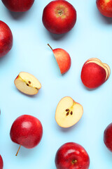 Fresh ripe red apples on light blue background, flat lay