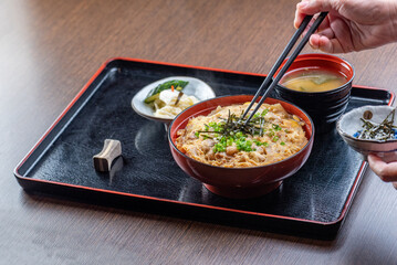A delicious Japanese dish with pork, rice, and various side dishes.
