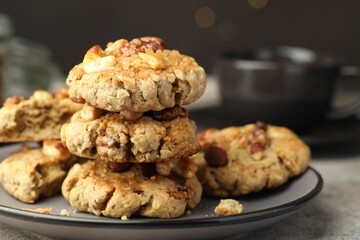 Tasty cookies with nuts on gray table, closeup