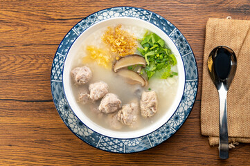 A bowl of congee with pork and century egg