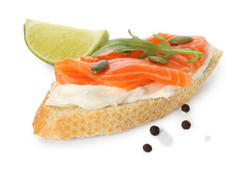 Delicious bruschetta with cream cheese, salmon and piece of lime isolated on white