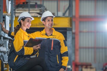 Factory apprenticeship. Man mentor teaching Female employees trainee operating machine looking...