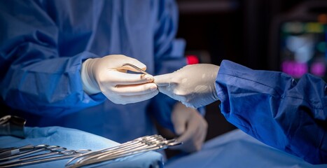 Team of surgery doctor in Operating Room hold hands scalpel surgical blade give to Surgeons During...