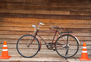 Vintage bicycle on old rustic dirty wall house, many stain on wood wall. Classic bike old bicycle...