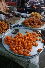 Fresh gulab jamun are being sold in a village fair, Making of Gulab Jamun in street side, delicious indian sweet gulab jamun 