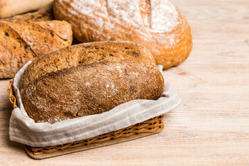 Homemade natural breads. Different kinds of fresh bread as background, perspective view with copy space