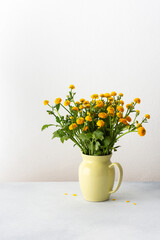 Home interior, Ranunculus flowers in a vase on the table, spring flowers buttercup