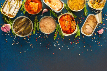 Different open tin cans with canned fish like salmon, mackerel, sprat, sardine, tuna, and herring,...