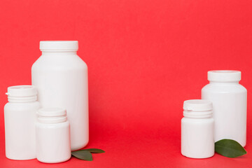 supplement pills with medicine bottle health care and medical top view. Vitamin tablets. Top view mockup bottle for pills and vitamins with green leaves, natural organic bio supplement, copy space