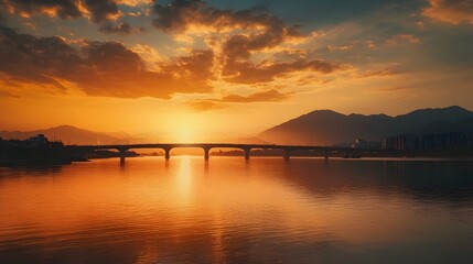 Obraz premium Golden Sunset Over Bridge and Mountain River Scene