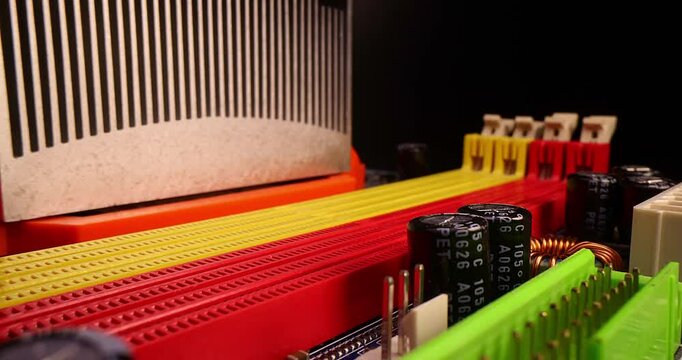 Computer motherboard and memory slot close up, DDR DIMM on a black background, slow motion.
