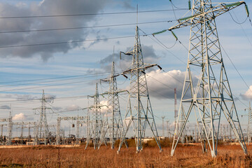 Electric Power Transmission Lines Across Rural Landscape Under a Blue Sky