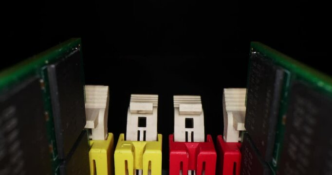 Slow motion of motherboard components - memory slots, ddr dimm memory, processor, sata, capacitors, chips, PCI on a black background close-up. Red, yellow, blue, orange, black , white  connectors.