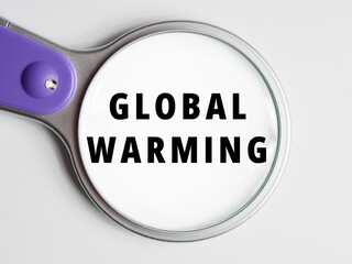 GLOBAL WARMING text through magnifying glass background